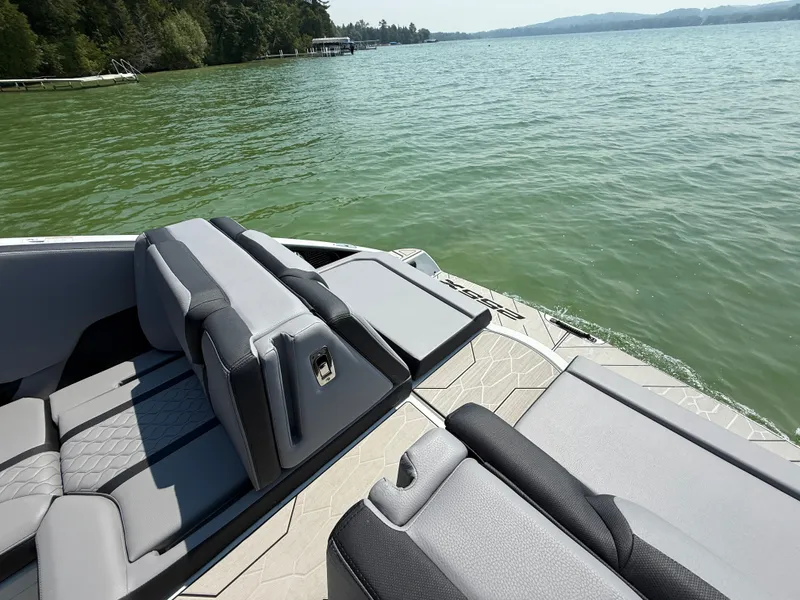 Slide: The Image of 2025 Yamaha Boats 255 XD on a serene lake surrounded by lush greenery. - 4