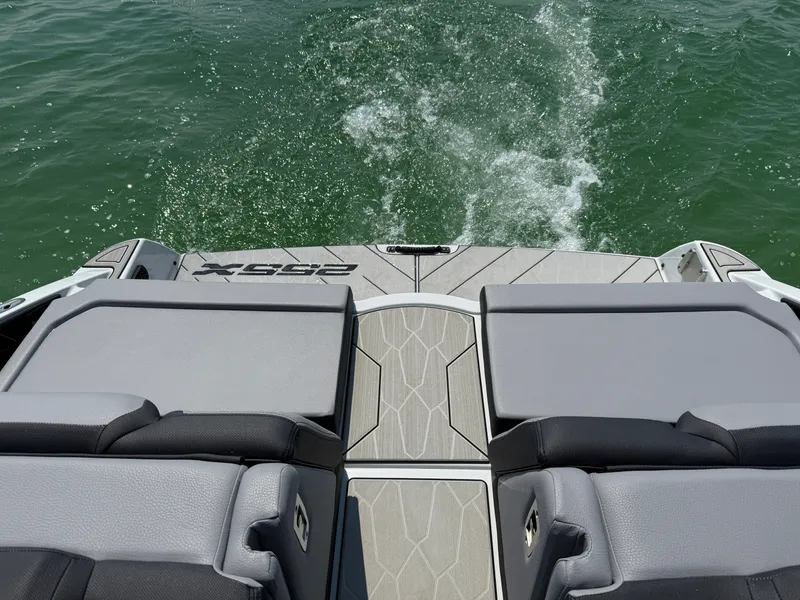 Slide: The Image of 2025 Yamaha Boats 255 XD on a serene lake, surrounded by lush greenery. - 5