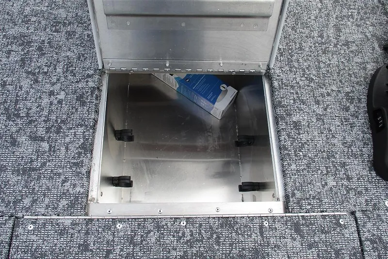 Slide: The Image of Open storage compartment on 2026 Tracker Pro 170 boat with gray carpeted flooring. - 12
