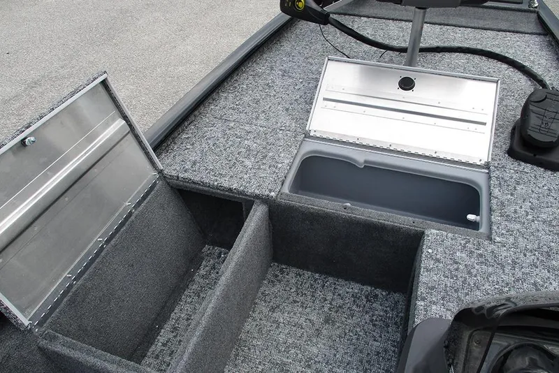 Slide: The Image of 2026 Tracker Pro 170 boat interior with open storage compartments and carpeted flooring. - 14