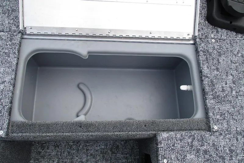 Slide: The Image of Open storage compartment in 2026 Tracker Pro 170 boat, featuring gray interior and carpeted edges. - 15