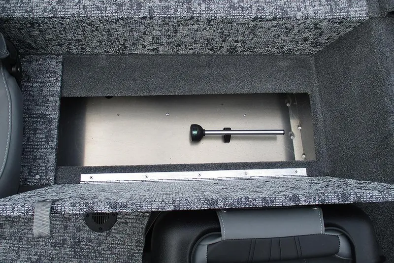 Slide: The Image of Interior storage compartment of 2026 Tracker Pro 170 boat, featuring a secure latch system. - 19