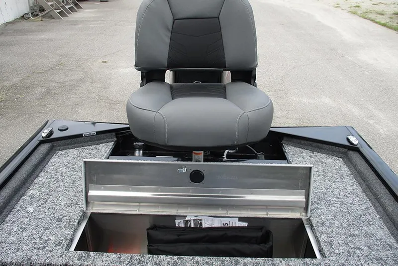 Slide: The Image of 2026 Tracker Pro 170 boat seat with open storage compartment on a textured deck. - 21