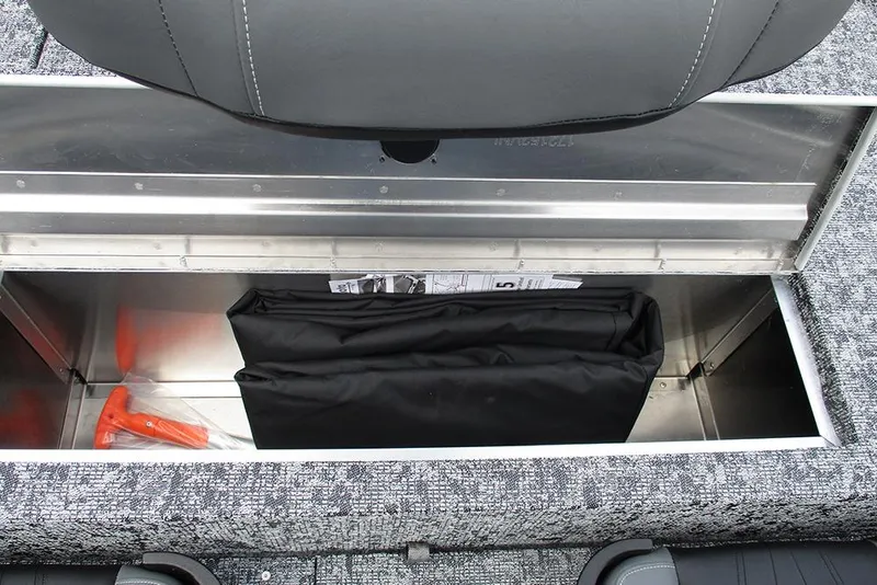 Slide: The Image of 2026 Tracker Pro 170 storage compartment with tools and folded cover. - 22