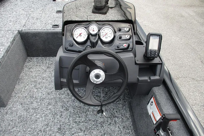 Slide: The Image of 2026 Tracker Pro 170 boat dashboard with steering wheel, gauges, and navigation system. - 23