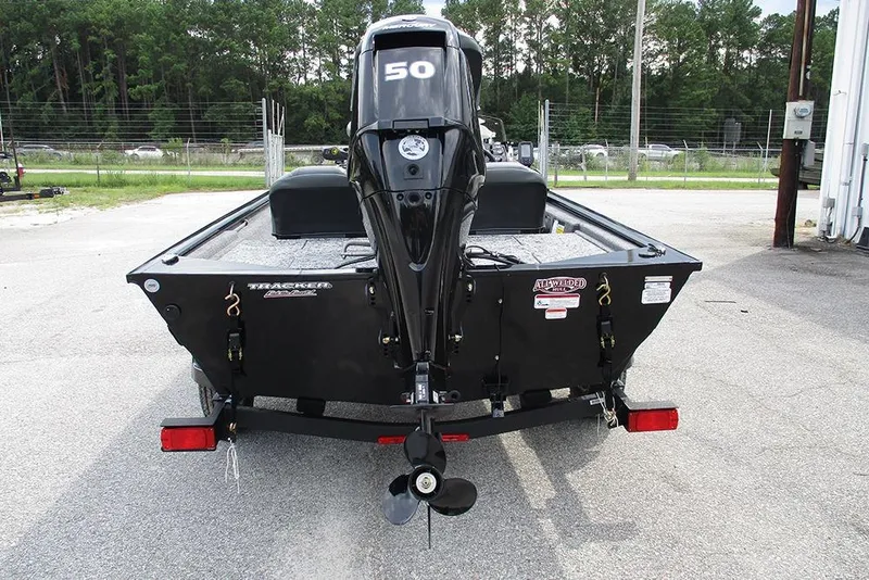 Slide: The Image of 2026 Tracker Pro 170 boat with a 50 HP outboard motor, parked outdoors. - 8