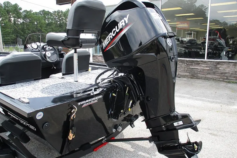 Slide: The Image of 2026 Tracker Pro 170 boat with Mercury outboard motor, parked outside a showroom. - 9