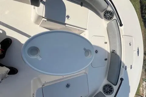 Slide: The Image of 2026 Carolina Skiff 21 Ultra Elite boat interior with seating and table setup. - 7