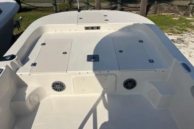 Slide: The Image of 2026 Carolina Skiff 23 LS boat deck with storage compartments and speakers. - 8