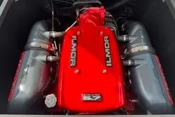Slide: The Image of 2014 MasterCraft X10 engine with red Ilmor cover, showcasing powerful performance. - 13