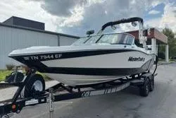 Slide: The Image of 2014 MasterCraft X10 boat on trailer, parked outdoors under cloudy sky. - 3