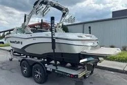 Slide: The Image of 2014 MasterCraft X10 boat on trailer, parked outdoors near a building. - 4