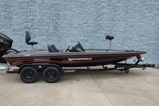 The Image of 2026 Phoenix 721zxl bass boat on trailer, side view against gray wall. - 1