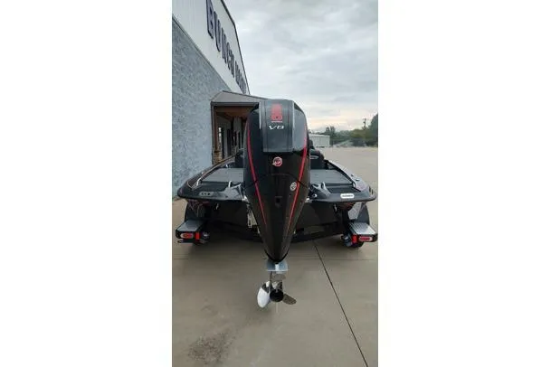 Slide: The Image of 2026 Phoenix 721zxl boat with V8 engine, parked outside a building on a cloudy day. - 11