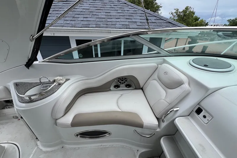 Slide: The Image of 2016 Crownline 264 CR boat interior with cushioned seating and built-in sink. - 10