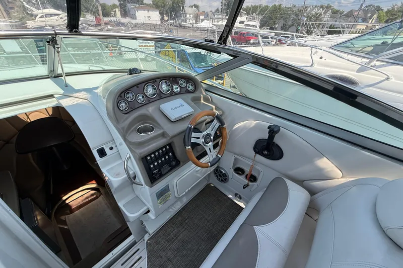Slide: The Image of 2016 Crownline 264 CR boat cockpit with steering wheel and control panel. - 11