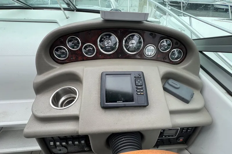 Slide: The Image of Dashboard of a 2016 Crownline 264 CR boat with gauges and Garmin device. - 12