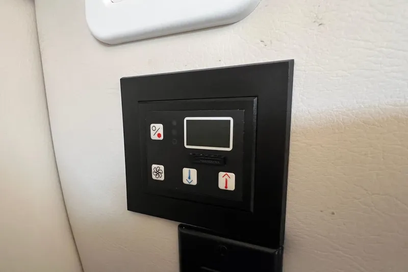 Slide: The Image of Control panel on a 2016 Crownline 264 CR boat interior wall. - 23