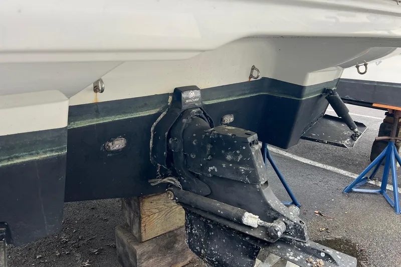 Slide: The Image of 2016 Crownline 264 CR boat stern with Mercury outdrive on wooden blocks. - 5