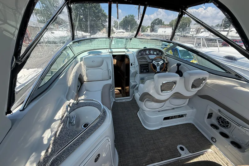Slide: The Image of 2016 Crownline 264 CR boat interior with helm, seating, and sink. - 8