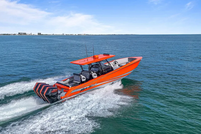 Slide: The Image of 2026 Nor-Tech 390 Sport Center Console boat cruising on open water. - 14