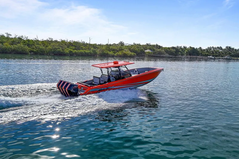 Slide: The Image of 2026 Nor-Tech 390 Sport Center Console boat cruising on a sunny day. - 15