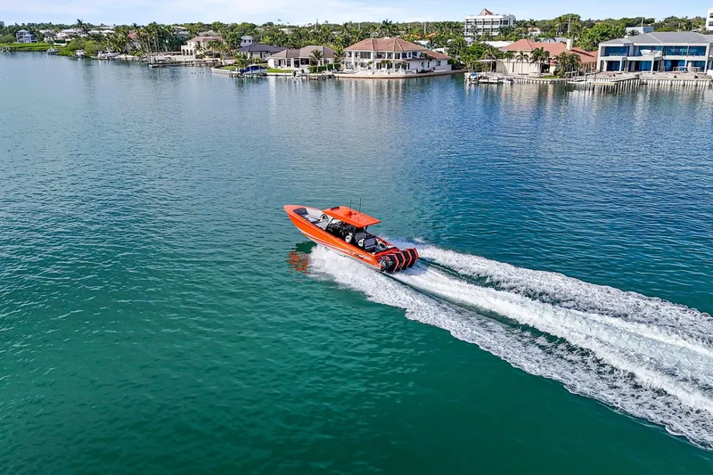 Slide: The Image of 2026 Nor-Tech 390 Sport Center Console cruising on a scenic waterfront. - 16