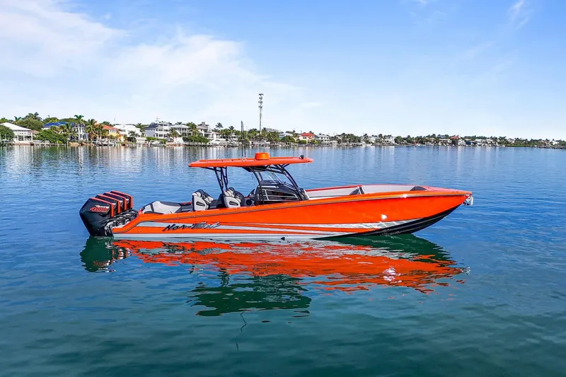 Slide: The Image of 2026 Nor-Tech 390 Sport Center Console boat on calm water, vibrant orange design. - 18