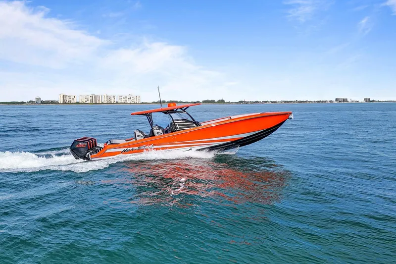 Slide: The Image of 2026 Nor-Tech 390 Sport Center Console boat cruising on open water. - 2
