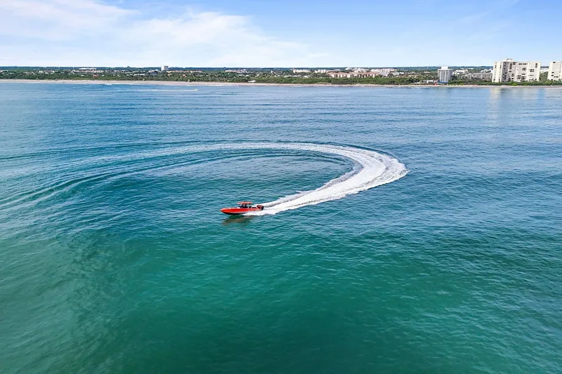 Slide: The Image of 2026 Nor-Tech 390 Sport Center Console making a sharp turn on open water. - 24