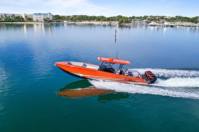 Slide: The Image of 2026 Nor-Tech 390 Sport Center Console boat cruising on calm water. - 26