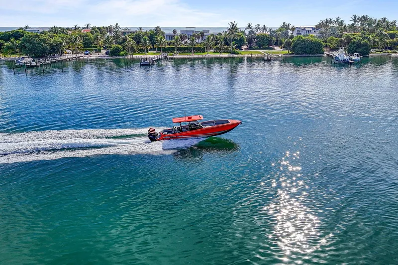 Slide: The Image of 2026 Nor-Tech 390 Sport Center Console cruising on a sunny, tropical waterway. - 27
