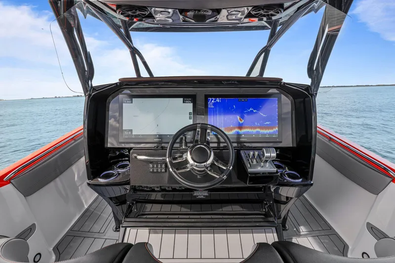 Slide: The Image of 2026 Nor-Tech 390 Sport Center Console helm with advanced navigation displays on open water. - 31