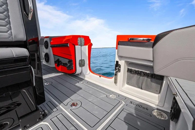 Slide: The Image of 2026 Nor-Tech 390 Sport Center Console boat interior with open deck and sea view. - 34