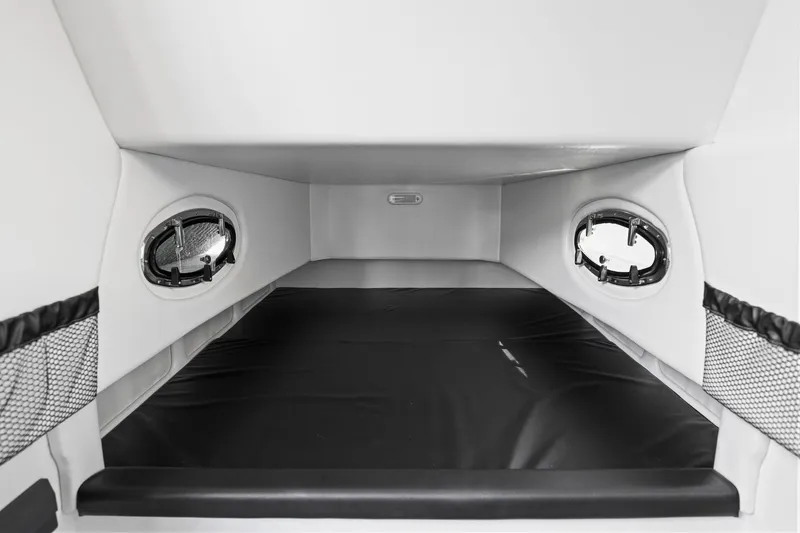 Slide: The Image of Interior cabin of 2026 Nor-Tech 390 Sport Center Console boat, featuring sleek design and portholes. - 36