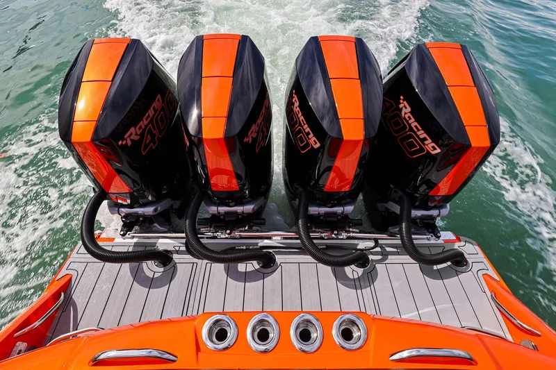 Slide: The Image of 2026 Nor-Tech 390 Sport Center Console with four powerful outboard engines on water. - 38