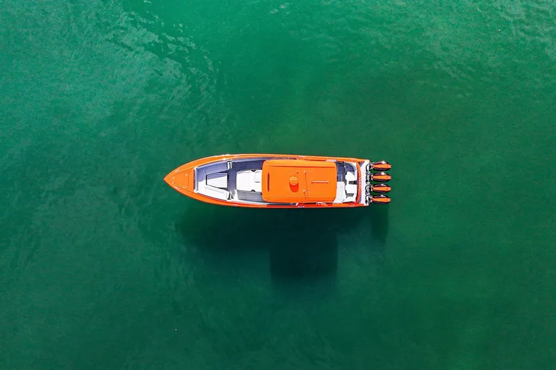 Slide: The Image of Aerial view of 2026 Nor-Tech 390 Sport Center Console boat on green water. - 4