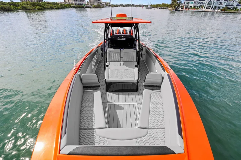 Slide: The Image of 2026 Nor-Tech 390 Sport Center Console boat with orange accents on calm water. - 43