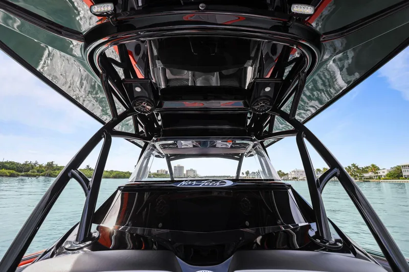 Slide: The Image of 2026 Nor-Tech 390 Sport Center Console boat on water, showcasing sleek design and modern features. - 44