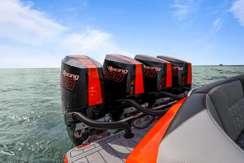 Slide: The Image of 2026 Nor-Tech 390 Sport Center Console with four powerful outboard engines on open water. - 46