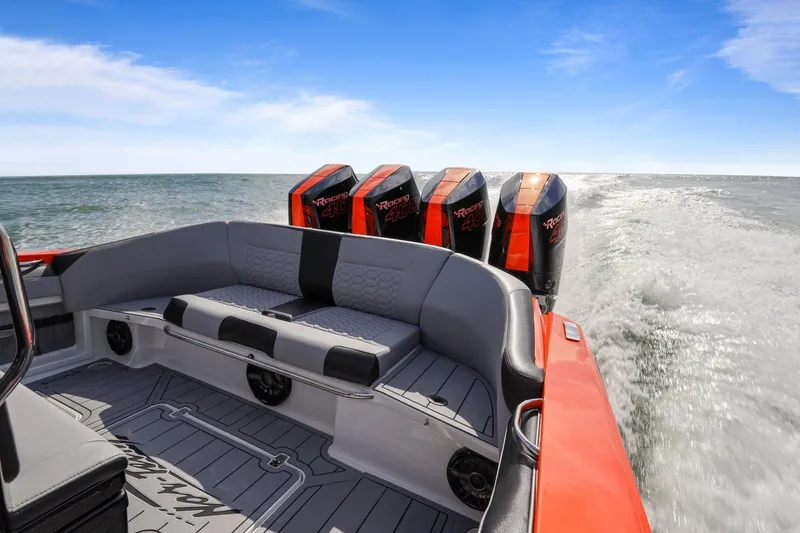 Slide: The Image of 2026 Nor-Tech 390 Sport Center Console boat with powerful outboard engines on open water. - 48