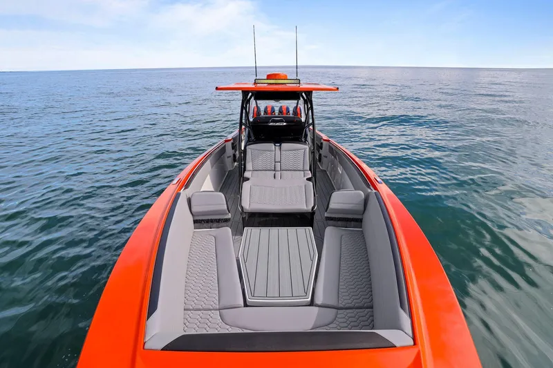 Slide: The Image of 2026 Nor-Tech 390 Sport Center Console boat on open water, featuring sleek design and spacious seating. - 49