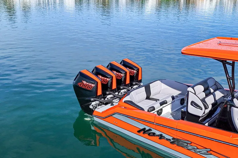 Slide: The Image of 2026 Nor-Tech 390 Sport Center Console with triple Racing 400 engines on calm water. - 5