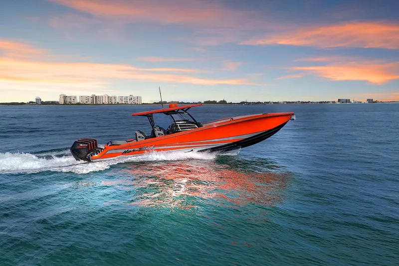 Slide: The Image of 2026 Nor-Tech 390 Sport Center Console boat cruising on open water at sunset. - 6