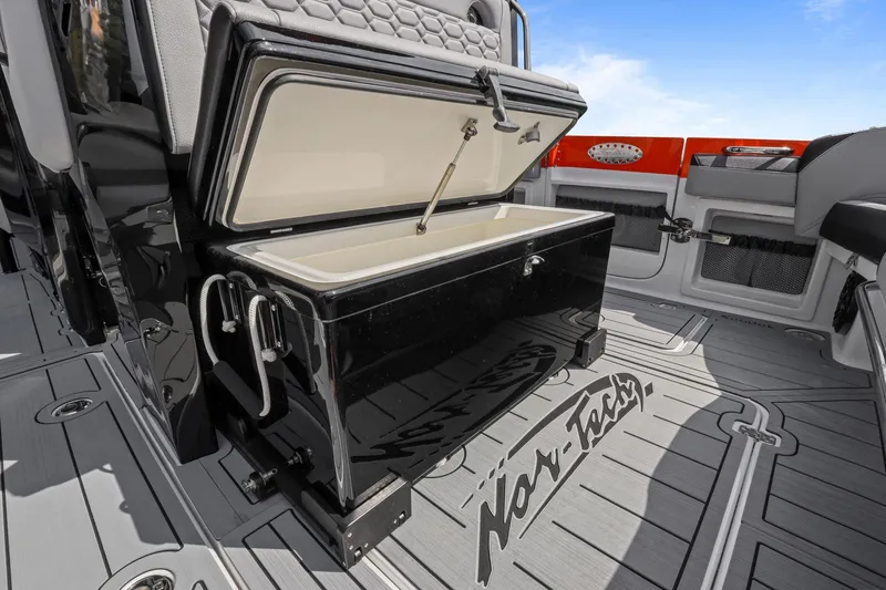 Slide: The Image of 2026 Nor-Tech 390 Sport Center Console interior with open storage compartment. - 64