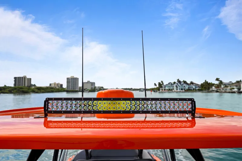 Slide: The Image of 2026 Nor-Tech 390 Sport Center Console with LED light bar on water. - 65