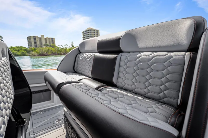 Slide: The Image of Luxurious seating on 2026 Nor-Tech 390 Sport Center Console boat with scenic waterfront view. - 68