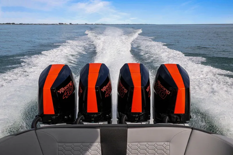 Slide: The Image of 2026 Nor-Tech 390 Sport Center Console with four powerful outboard engines on open water. - 70