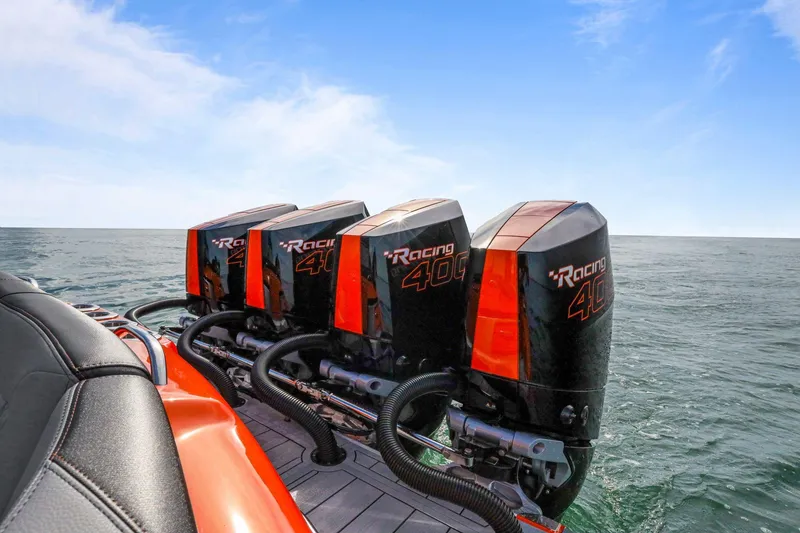 Slide: The Image of 2026 Nor-Tech 390 Sport Center Console with four powerful outboard engines on open water. - 73