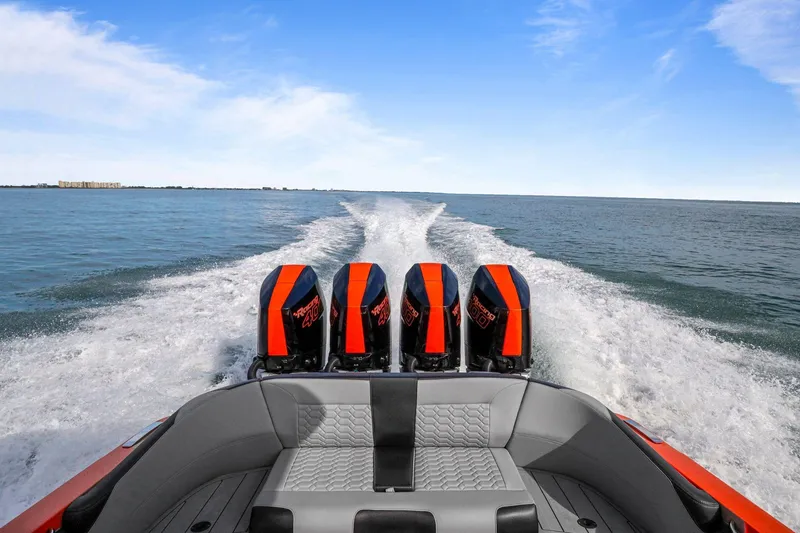 Slide: The Image of 2026 Nor-Tech 390 Sport Center Console speeding on open water, showcasing powerful engines. - 76